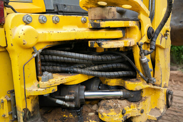 Hydraulic pipes of heavy industry machine. Details of tractor, bulldozer, excavator. Low key....