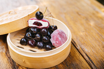 Wooden bowl with cherries and ice cream a sweet and fruity dessert dish. Asian dessert mochi