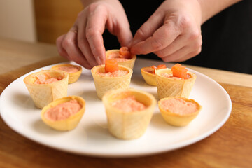Waffle baskets with pate add salmon. Preparation of fish canapés