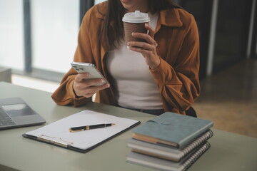 Asian businesswoman working on laptop computer Look for job online, freelance looking and typing on notebook on table, lifestyle of woman studying online