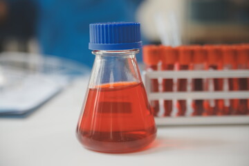 biochemical research scientist team working with microscope for coronavirus vaccine development in pharmaceutical research labolatory, selective focus