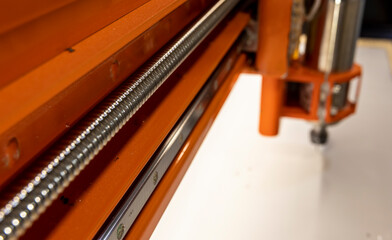 metal elements of a CNC machine in orange color
