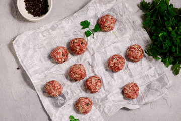 Raw beef meatballs on a cutting board .style hugge.top veiw