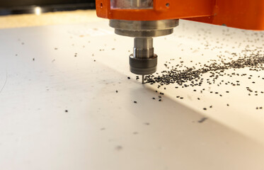 CNC milling of a composite aluminum cassette using a cutter, black small chips
