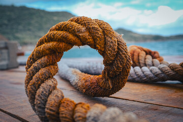 old rope on the wood boat deck blu sky clouds by the sea - obrazy, fototapety, plakaty