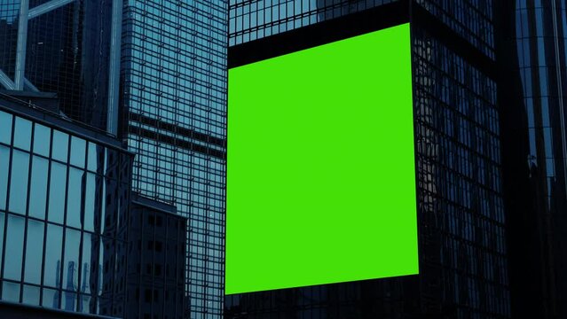 Night City large billboard with a green screen for advertising on the building wall.