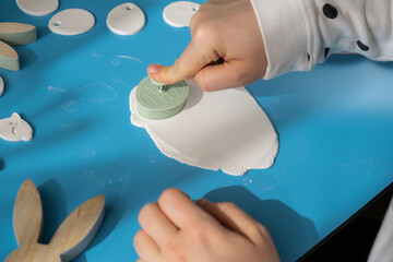 Workshop cutting figures Unrecognizable artist do it yourself air dry clay crafts for Easter...