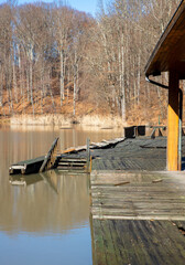 An old wooden pontoon on the shore of a lake