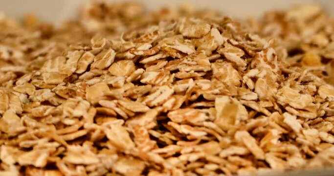 Extreme close-up of a plate full of spelled flakes. Spelled flakes contains thiocyanate, which has a revitalizing, immune-stimulating and anti-inflammatory effect