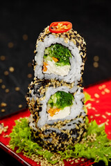 Stack of light vegetarian sushi rolls on red plate