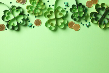 St Patrick's Day flat lay composition with four leaf clover paper art, gold coins, confetti.