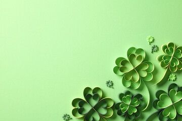 St Patrick's Day holiday background with green four leaf clover paper art. Top view, flat lay.