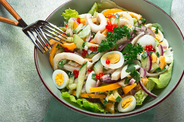 salad with squid, fresh cucumber, eggs, sweet pepper, red onion, with dressing, homemade, no people,