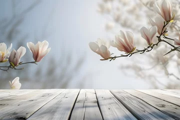 Tuinposter empty wooden table top with blooming white magnolia flowers,on a light gray background,product presentation design concept, layout © Наталья Лазарева