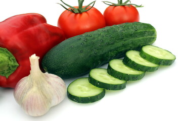 Fresh harvest of vegetables lie on a white background.