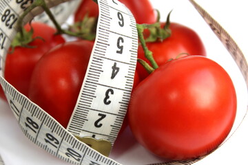 Red ripe tomatoes are wrapped with a centimeter soft ribbon.