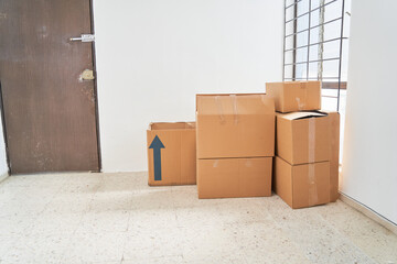 Moving in. Stack of cardboard boxes in the empty room