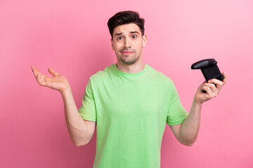 Photo of man in green t shirt holding game station joystick shrug shoulders dont know how solve...