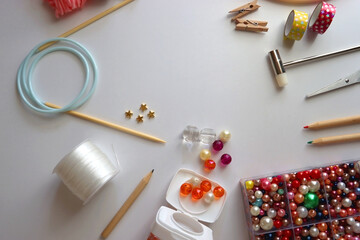 Various craft supplies on white background. Supplies for jewelry making, drawing and needlework. Flat lay.