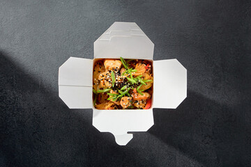 Delicious rice glass noodles with chicken fillet served in a takeaway box, perfect for a quick Asian meal