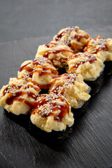 Sushi roll with sea scallop and unagi sauce; a decadent combination of ocean flavor and sweet glaze