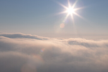 Beautiful sky with shining sun above the clouds at sunrise time.