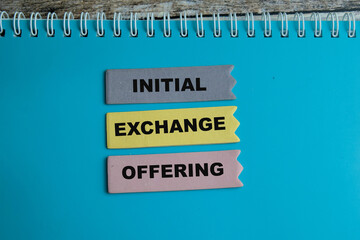 Concept of Initial Exchange Offering write on sticky notes isolated on Wooden Table.