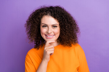 Fototapeta na wymiar Photo of pretty cute woman wear orange t-shirt smiling arm chin isolated purple color background