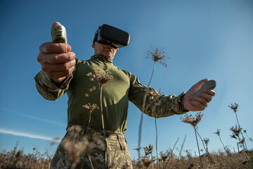 Modern army technology. Warfare operator using virtual reality glasses, vr controller. Pilot of...