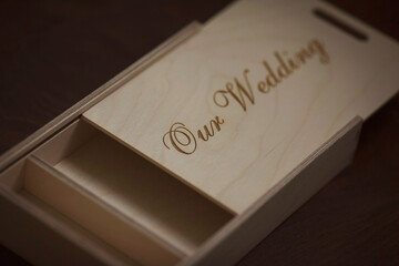 Wooden photo box for photo storage on wooden background. Box with flash with laser engraving 