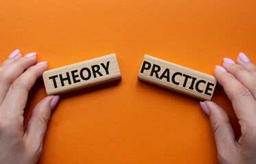 Theory or Practice symbol. Concept word Theory or Practice on wooden blocks. Businessman hand....