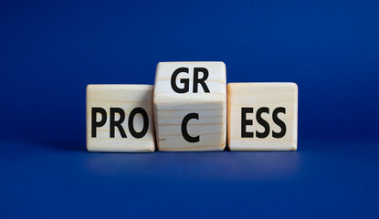 Process and Progress symbol. Wooden cubes with words Process and Progress. Beautiful deep blue background. Business and Process and Progress concept. Copy space