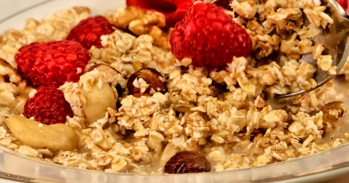 Nice close up video of a natural, healthy and very delicious muesli on a turning breakfast plate
