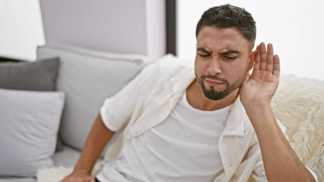 At home, young arab man joyfully soaking up the rumor menace, deaf to gossip, busy hearing life!