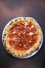 Pizza with salami and mozzarella cheese