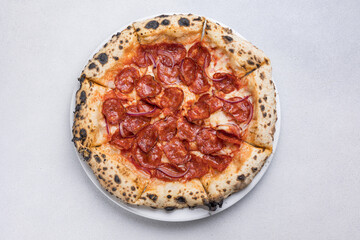 Pizza with salami and mozzarella cheese