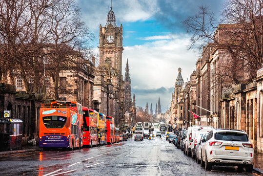 Edinburgh, Scotland - January 22nd 2024: cars and buses parked along Princes Street, with the Balmoral Hotel clock tower visible