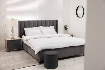 Fototapeta na wymiar Stylish bedroom interior with large bed and lamp