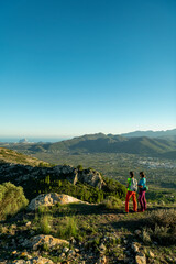 Obraz premium Two women hikers enjoying the beautiful nature from high above, Lliber, Alicante, Costa Blanca, Spain - stock photo