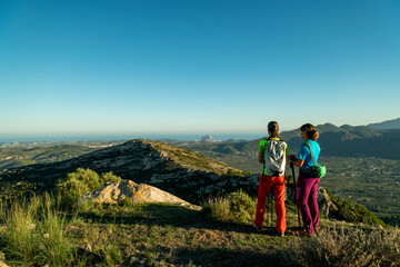 Two women hikers enjoying the beautiful nature from high above, Lliber, Alicante, Costa Blanca, Spain - stock photo