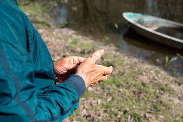 Fisherman's hands with a worm.
Close-up of a fisherman's hands by the river catching an earthworm to put on the hook.