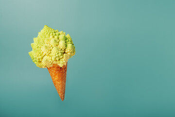 Plant based Ice cream concept. Waffle cone with vegetable. Decorative Romanesco cabbage as a...