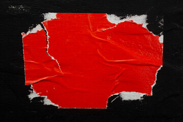 Red torn poster on the wall.