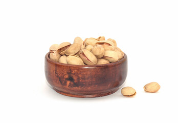 Pistachio nuts, pistachios in Wooden Bowl Isolated on a white background. 