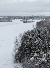 Winter landscape in the countryside of Latvia (next to Lake Siver), above trees and meadows.