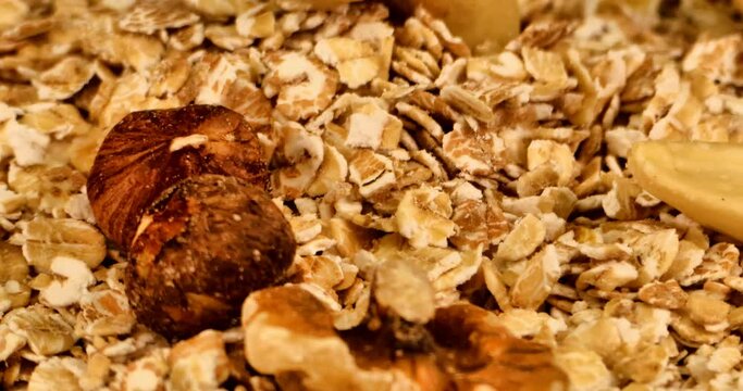 Extreme close-up of a plate full muesli with nuts and spelled flakes. Spelled flakes are rich in amino acids,