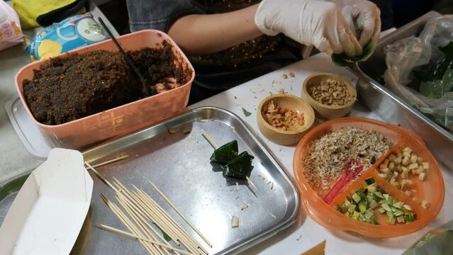 Making Miang Kham (traditional Southeast Asian herbal snack from Thailand and Laos), Traditional Thai snack. It&rsquo;s a snack containing different ingredients of herbs and vegetables. 