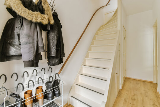 Cozy home entrance with staircase and clothing rack