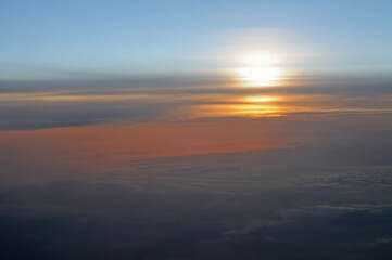 Fototapeta na wymiar Sunset above the clouds as seen from airplane, nature background