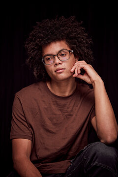 Studio portrait of young colored man with glasses on. Munich, Germany